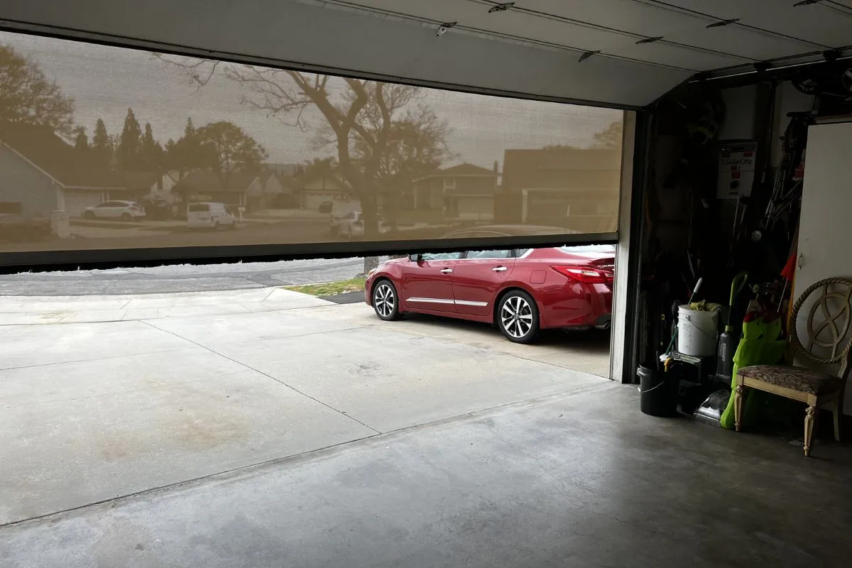 How a motorized retractable garage door screen works — housing, motor, side tracks, zipper
