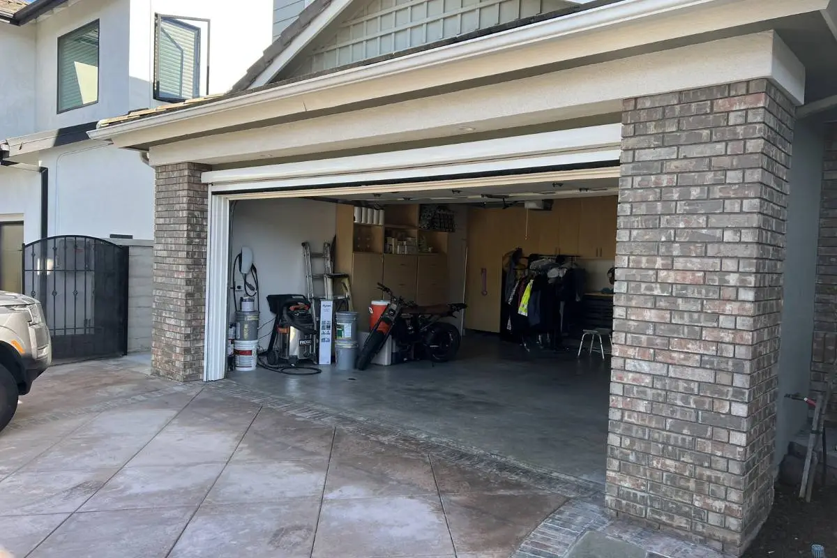 Home workshop in garage with motorized garage door screen for ventilation