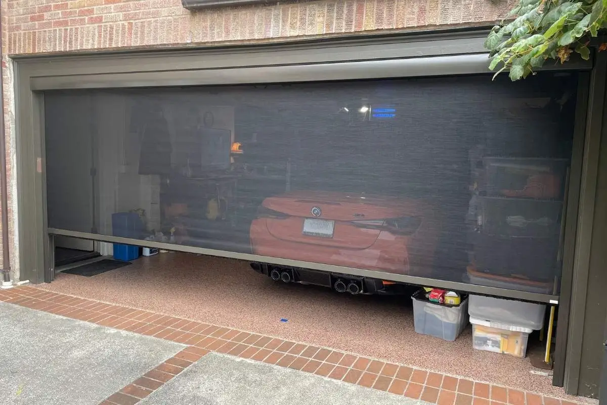 Garage entertainment space with retractable garage door screen deployed